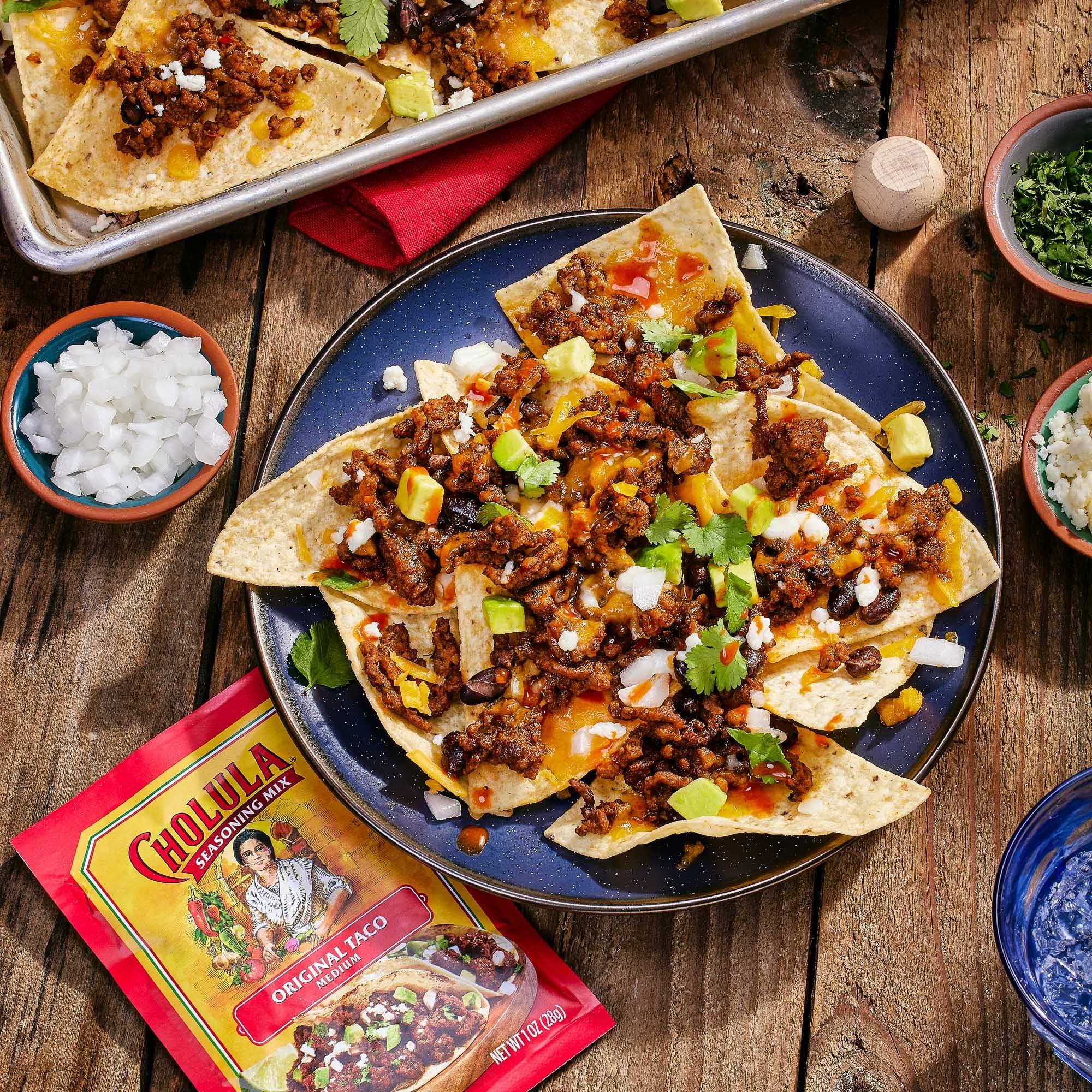 Cholula seasoned shrimp tacos served with lime showing versatile use