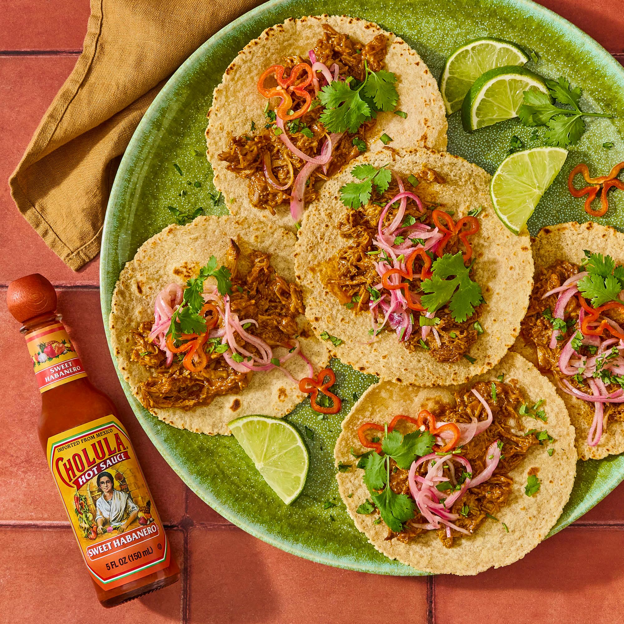Cholula bottle next to a fork showing 5 fl oz size and portioning