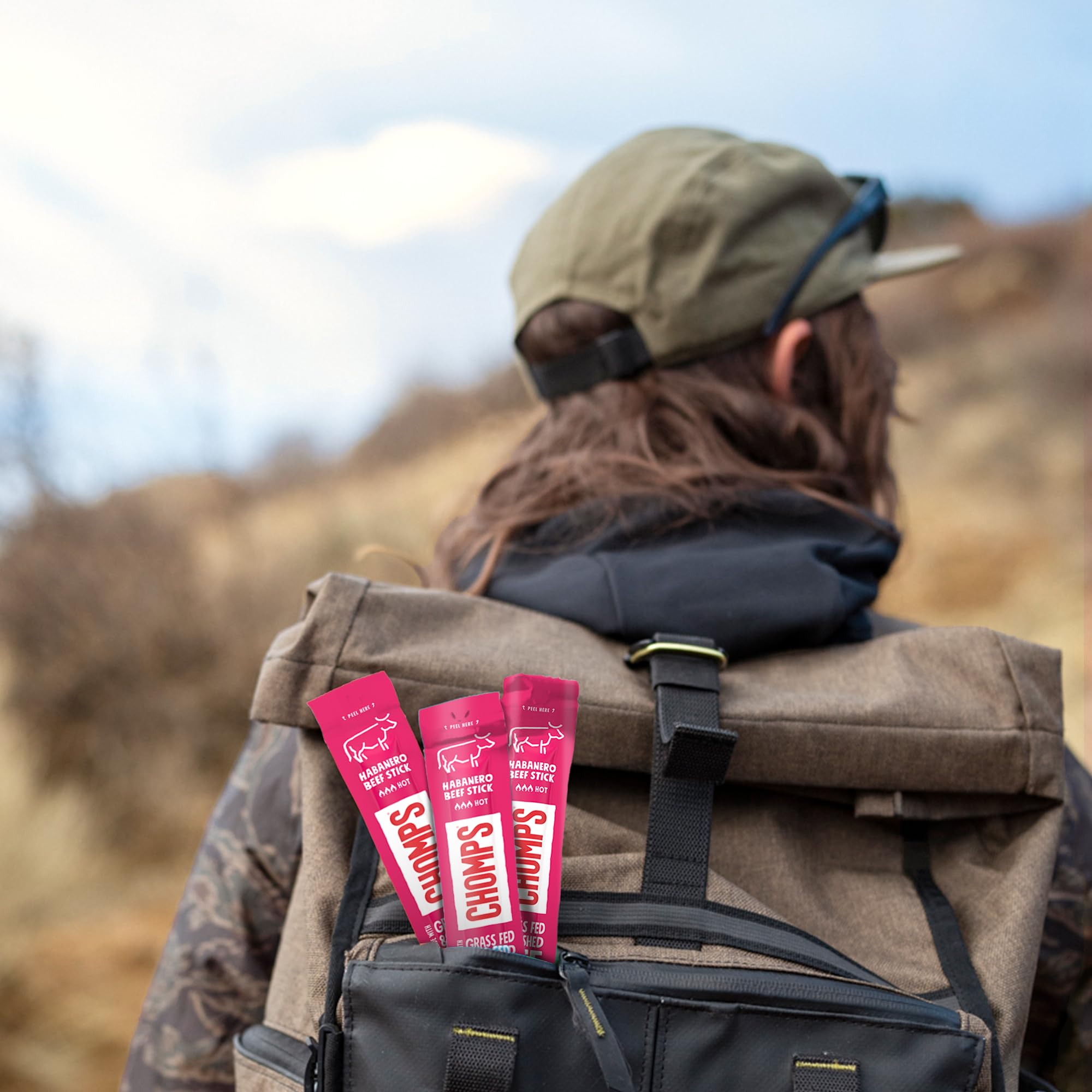 Chomps sticks inside a backpack illustrating portable protein on the go