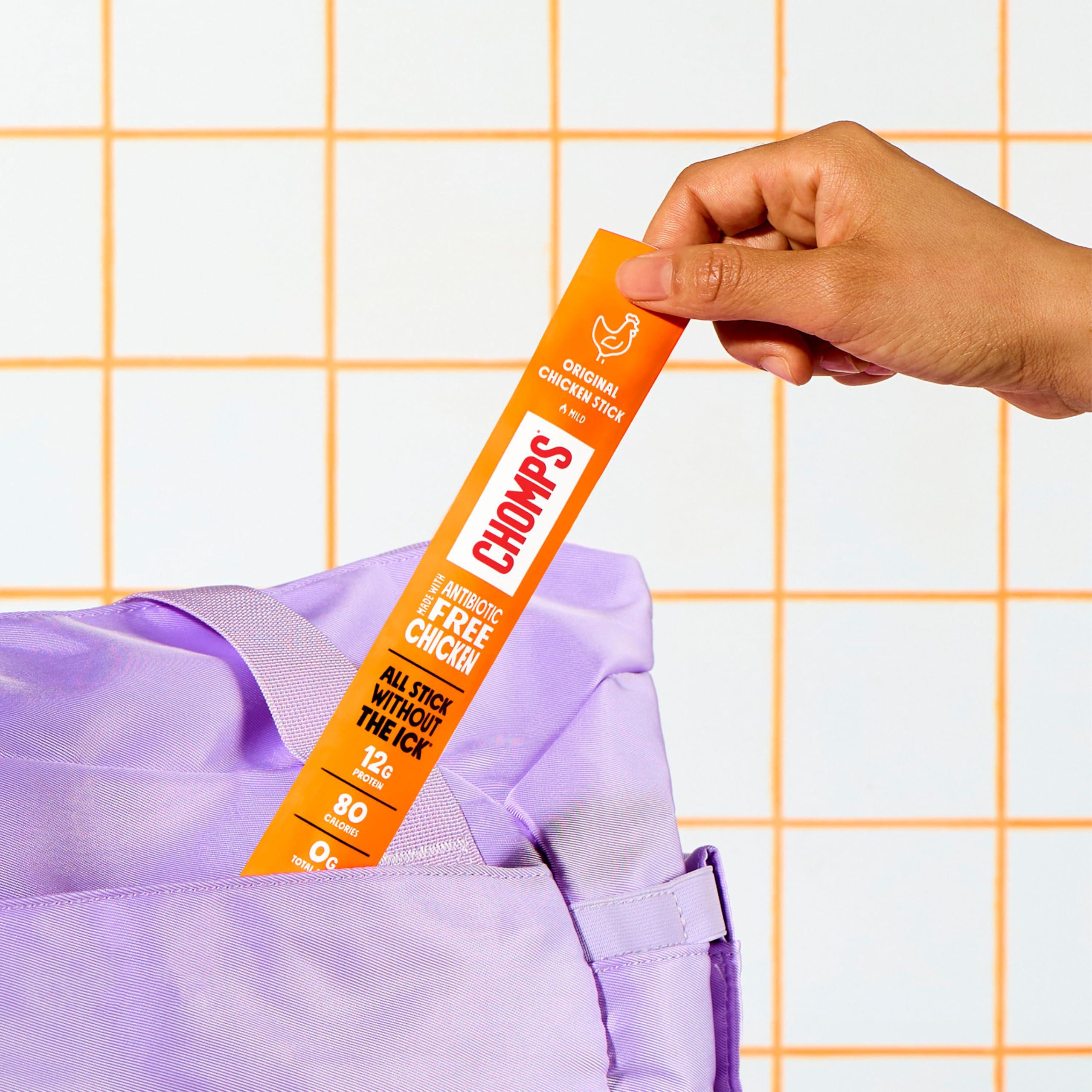 Chomps stick held in hand demonstrating portable size and convenience