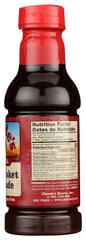 Claude's bottle beside measuring cup and label close-up demonstrating product details