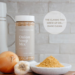 Clean Monday Meals seasoning sprinkled into soup illustrating quick flavor boost and convenience