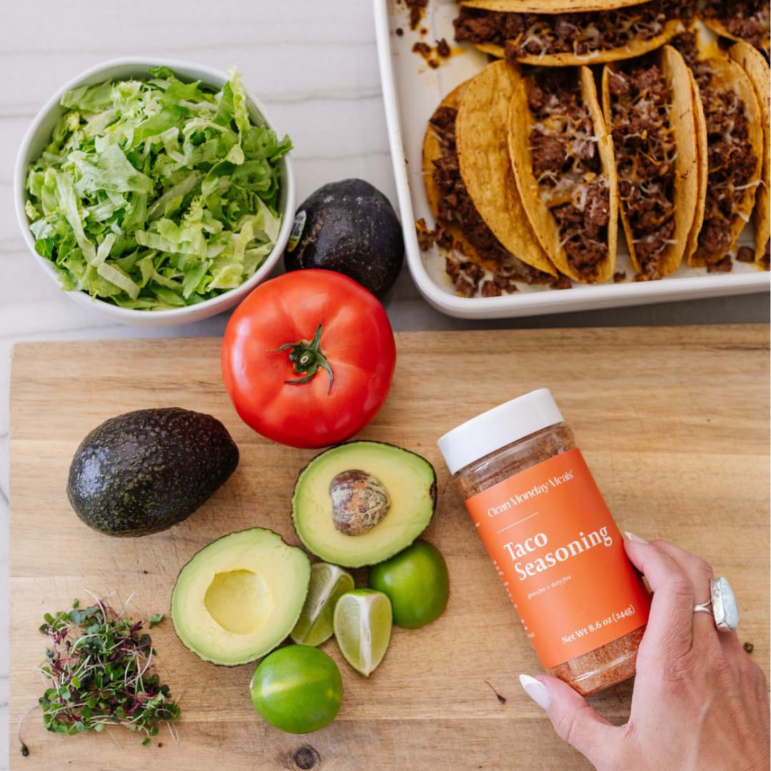 Clean Monday Meals seasoning spoonful over a bowl showing easy measuring and consistent seasoning benefit