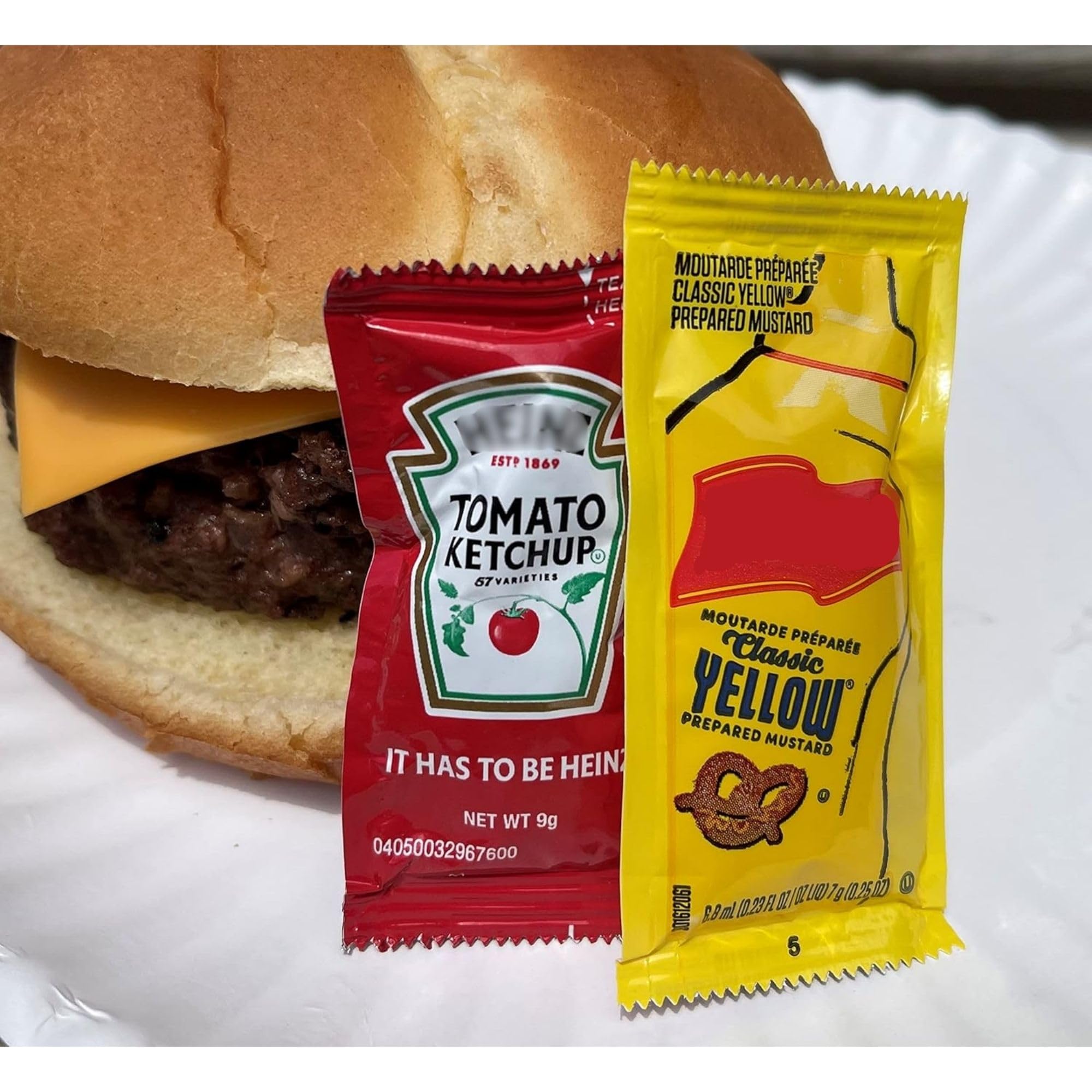 CMC Products packets on a picnic blanket with burgers highlighting outdoor convenience and mess-free service