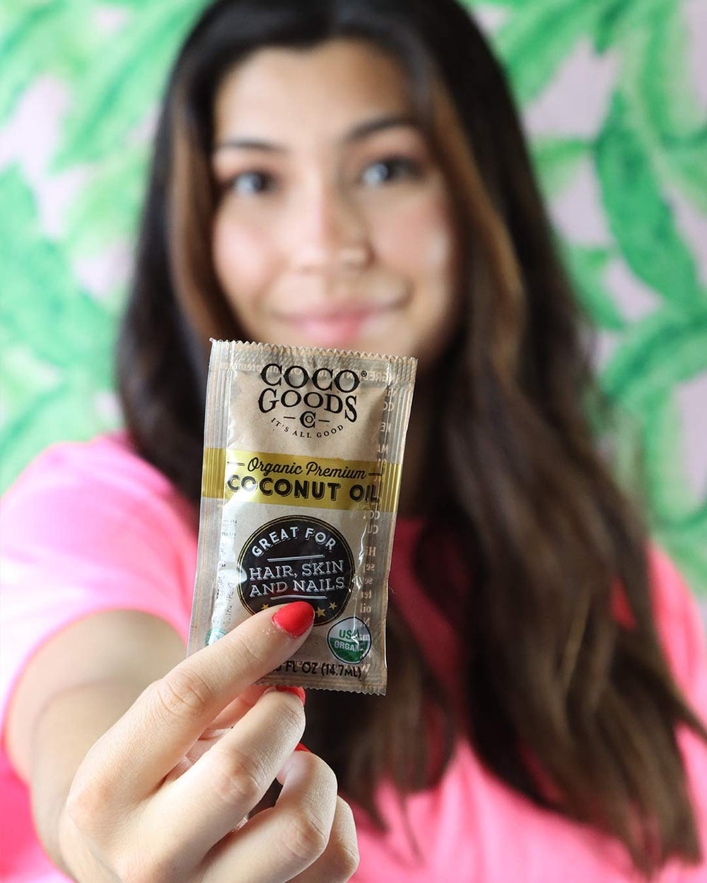 COCOGOODSCO applying coconut oil to hair for deep hydration benefits