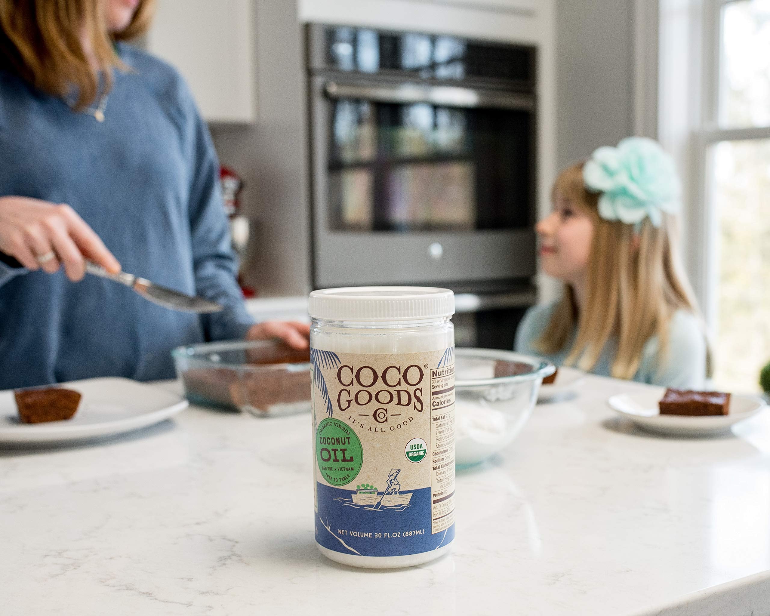 COCOGOODSCO pouring cold-pressed oil close-up showing smooth texture and purity