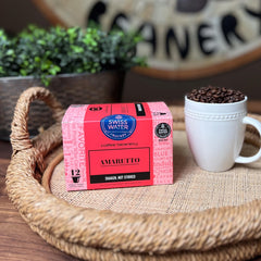Coffee Beanery amaretto pod inside a K-Cup brewer brewing fresh cup quickly