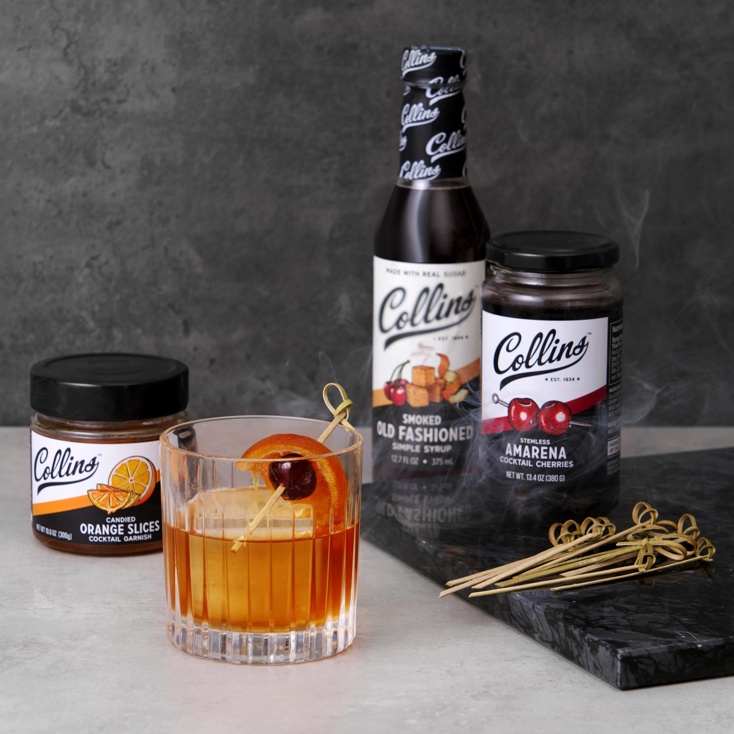 Collins smoked Old Fashioned poured in rocks glass showing smoky color and presentation