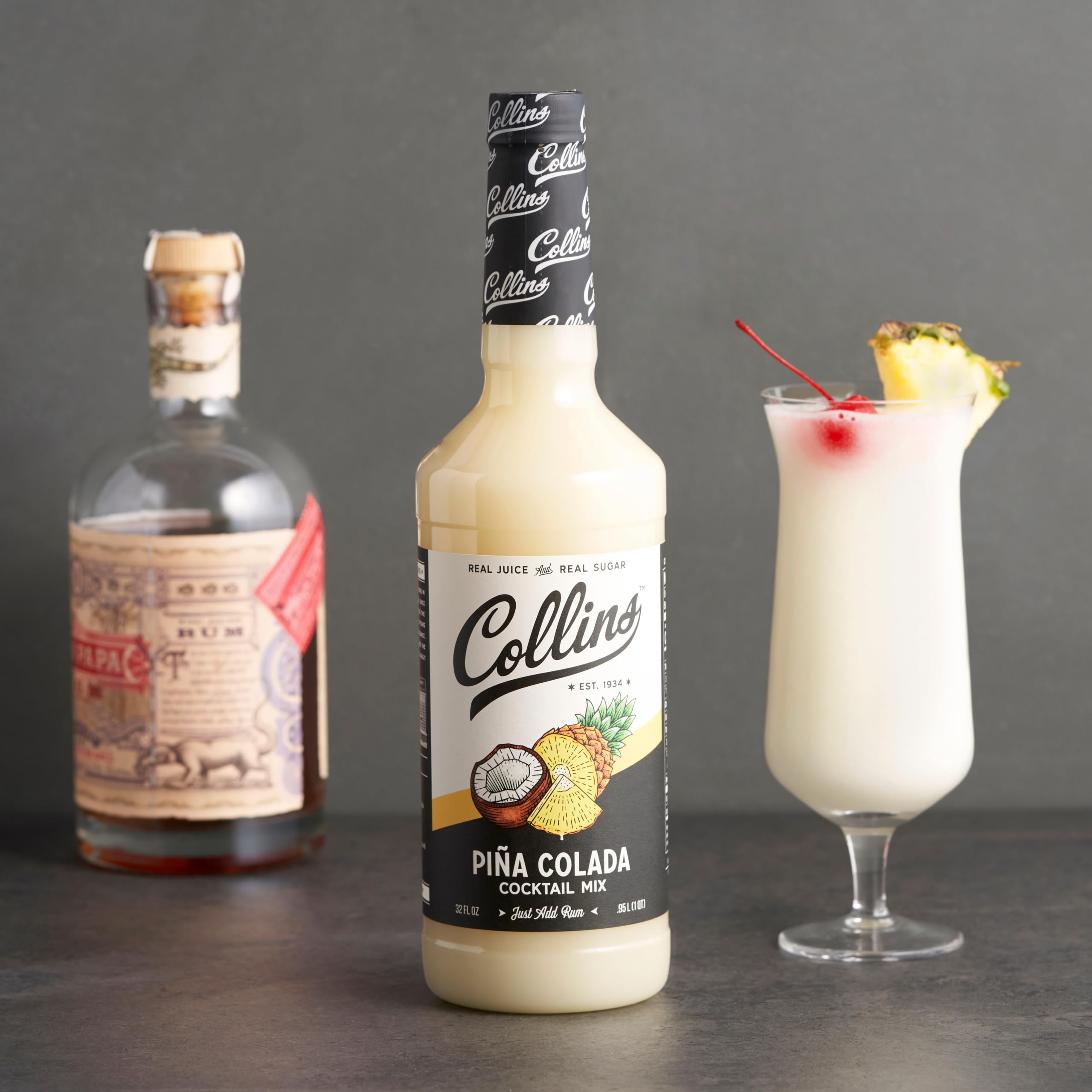 Collins bottle staged on home bar counter with tiki glass, inspires entertaining