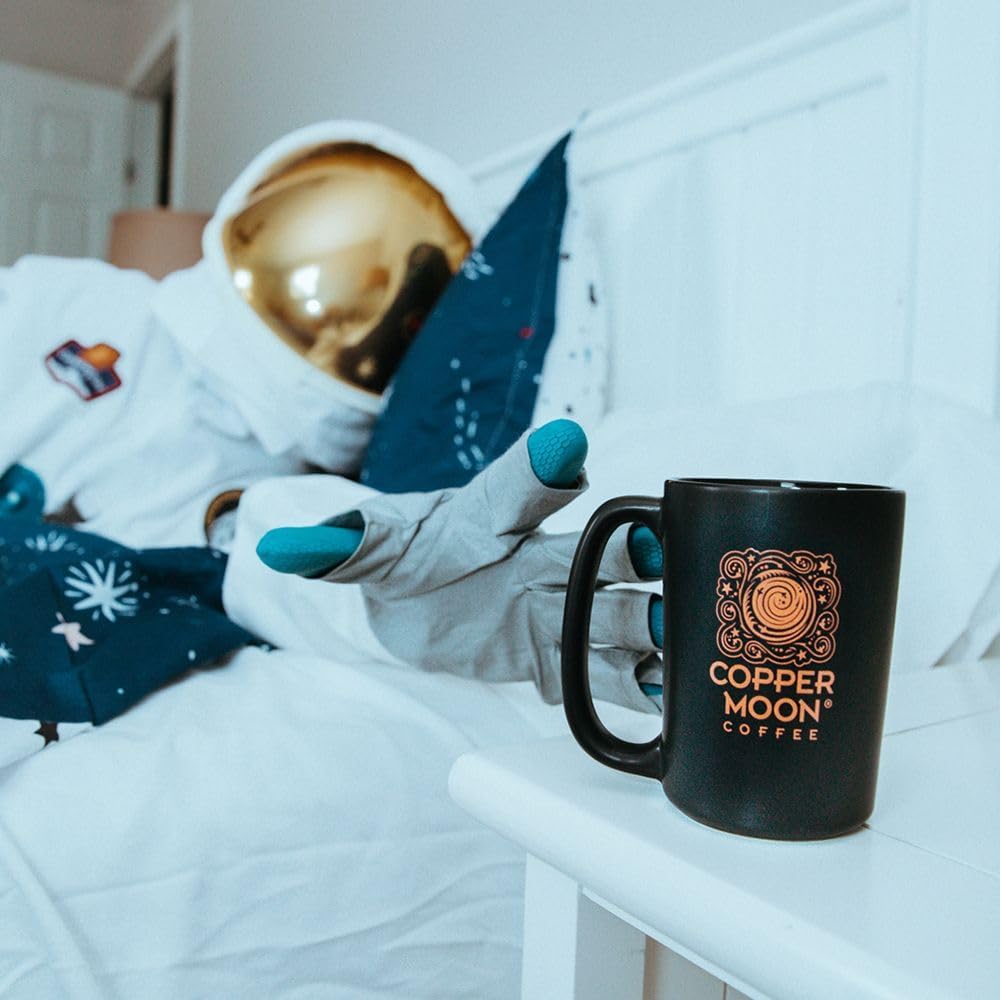 Copper Moon pod next to a standard measuring cup for size reference