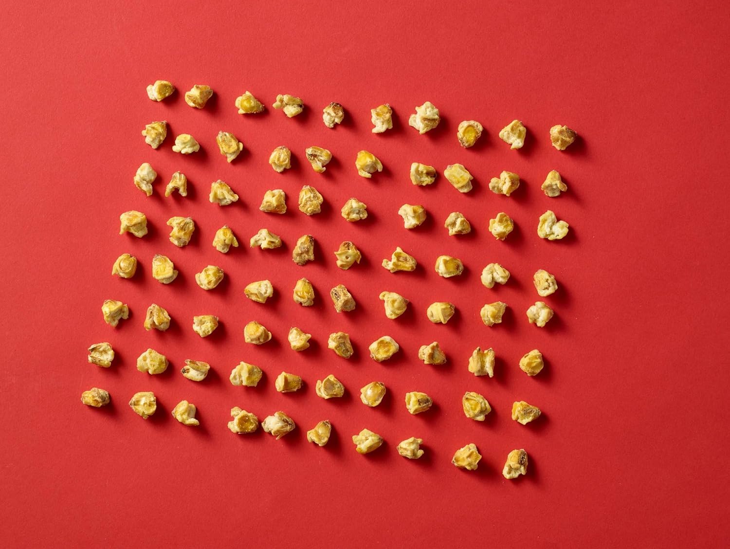 Hand holding Corn Nuts bag to show size and single-serve convenience for on-the-go