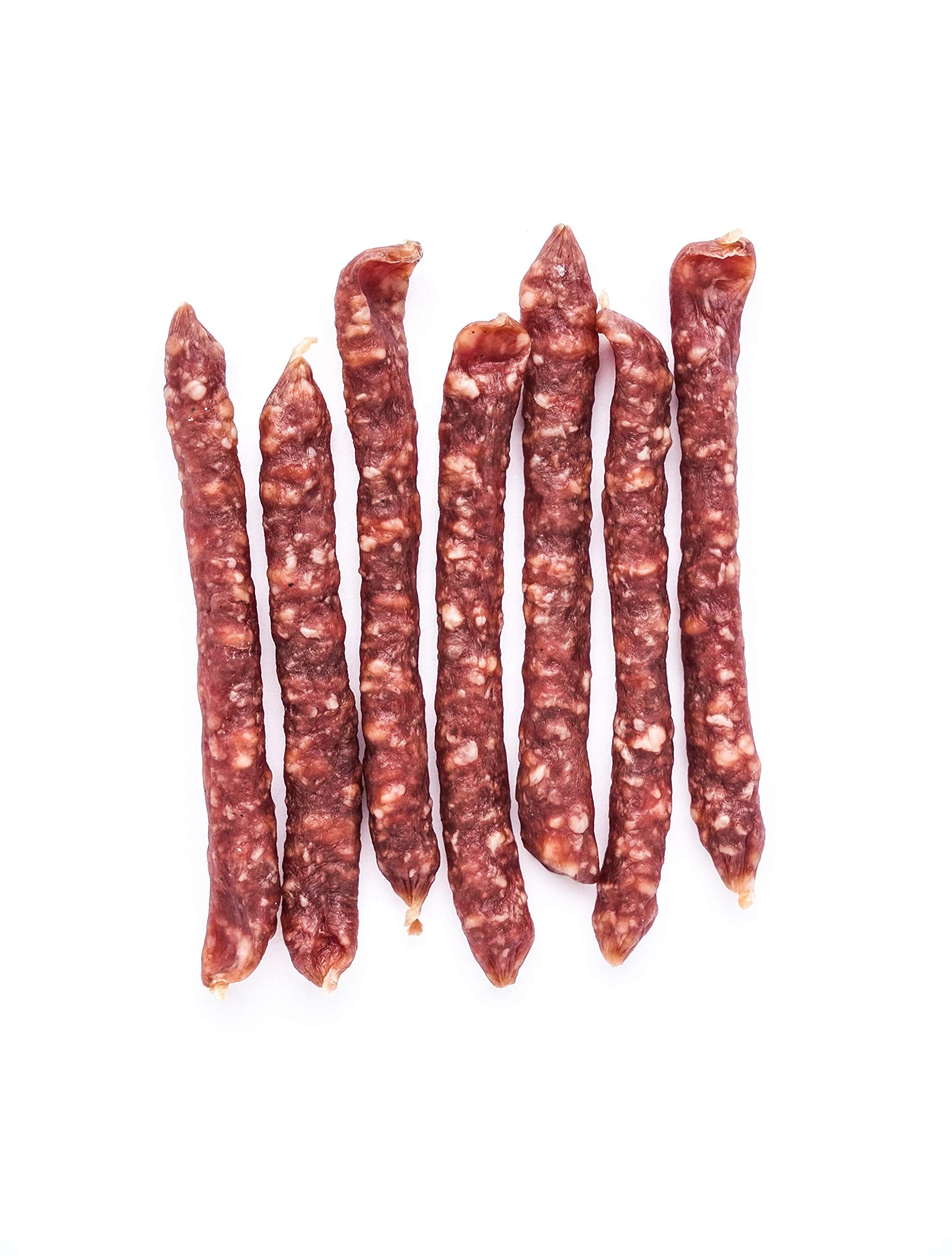 Creminelli salami mini held in hand illustrating portable single-serve portion