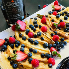 Crown Maple drizzled on pancakes adding deep flavor and glossy finish