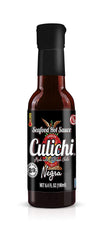 Culichi Chiltepin bottle pouring over ceviche adding sharp pepper brightness
