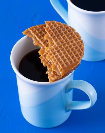 Daelmans stroopwafels on baking sheet warming to soften caramel filling