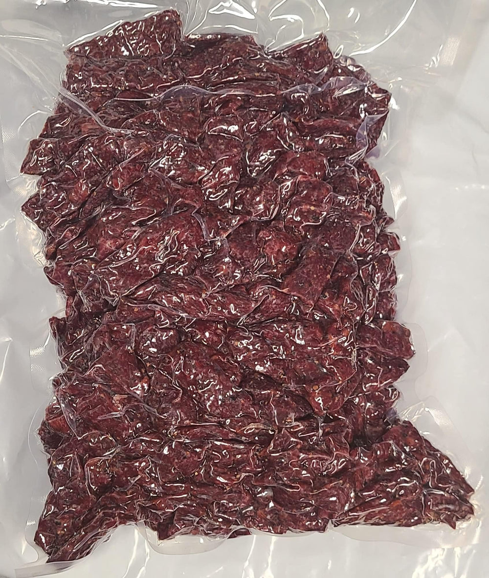 Dakota Trails jerky on campsite plate showing peppered flavor benefit as satisfying group snack