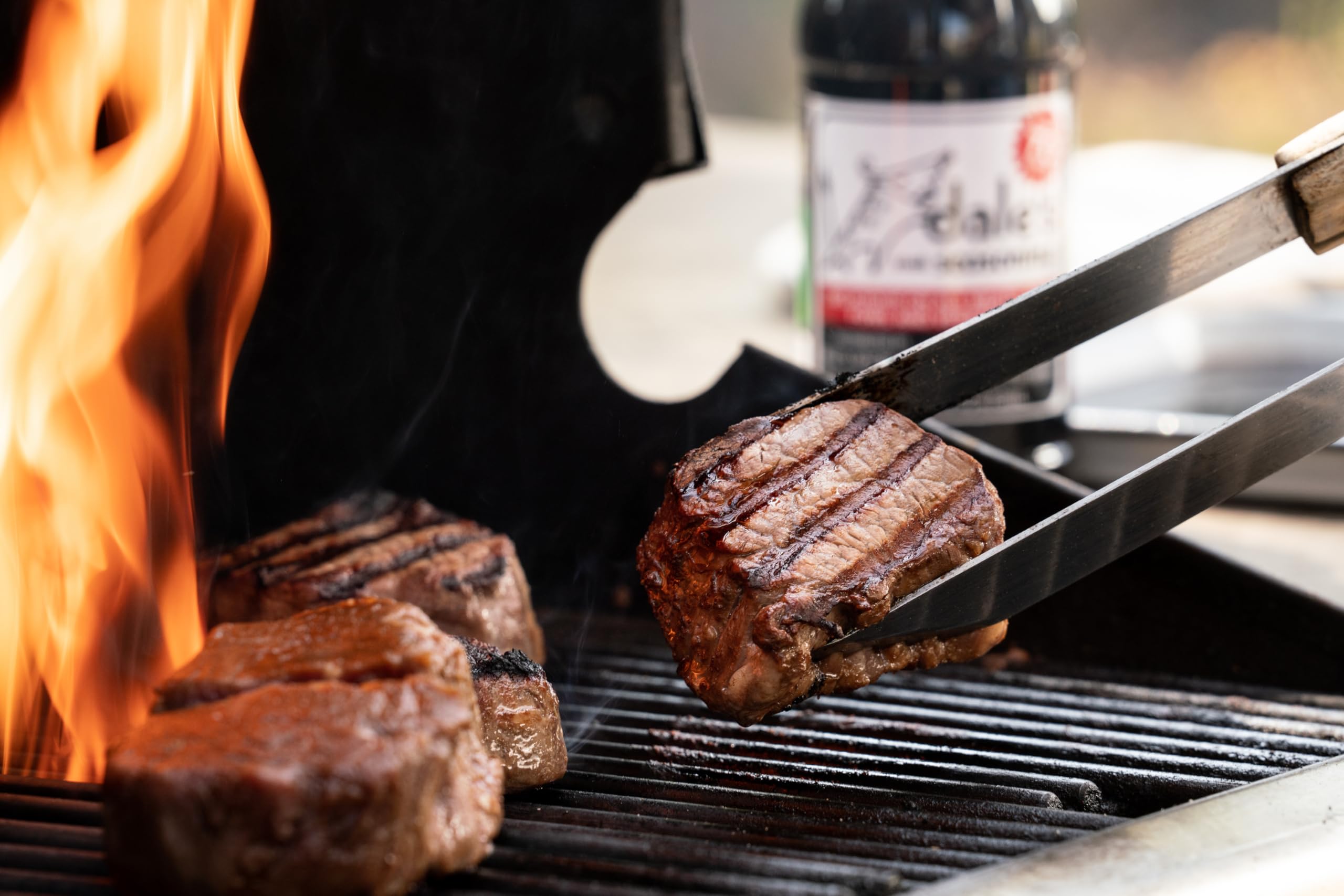 Dales bottle beside a backyard grill showing convenient outdoor use