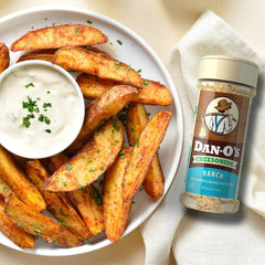 Dan-O's seasoning sprinkled on popcorn adding savory ranch-cheese flavor