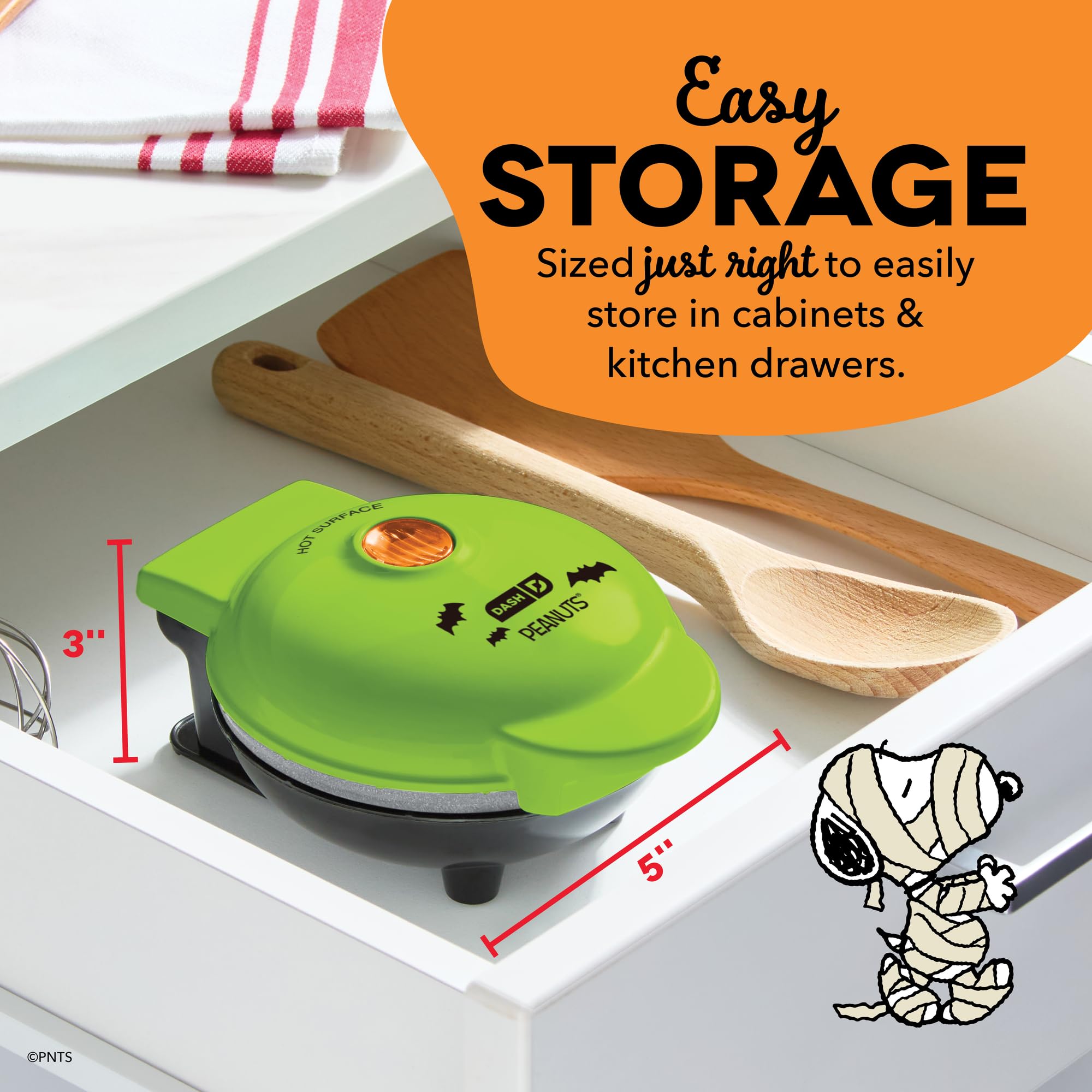 Dash Snoopy Vampire next to a mug for scale showing compact footprint and countertop fit