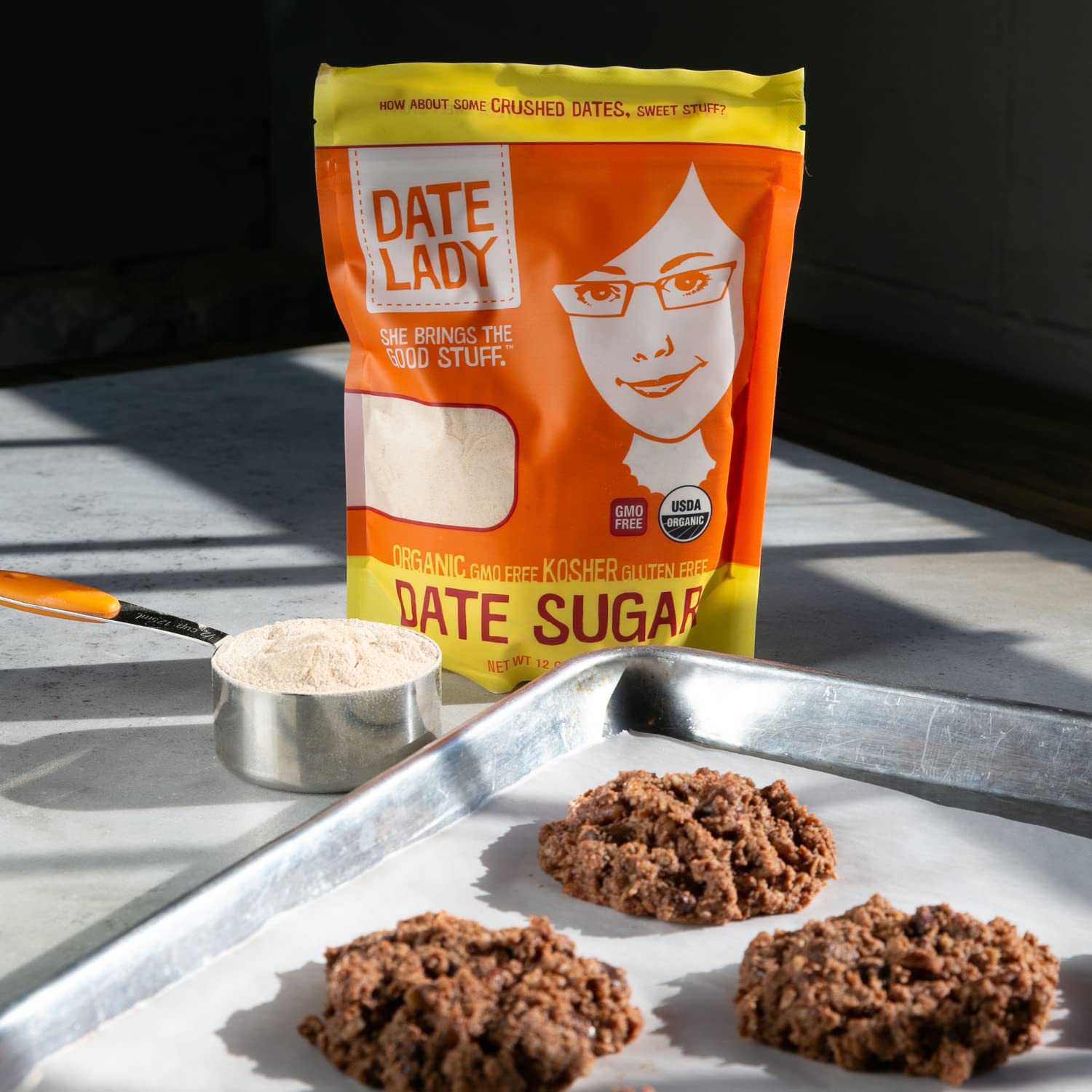Date Lady bag held in hand for scale, illustrates compact 1 lb size and stockable two-pack