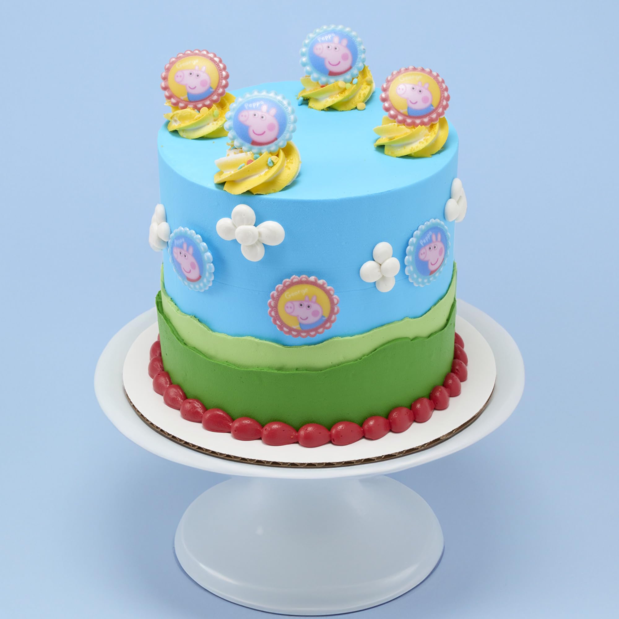 DecoPac Peppa Pig topper on cupcake in use enhancing party dessert appearance