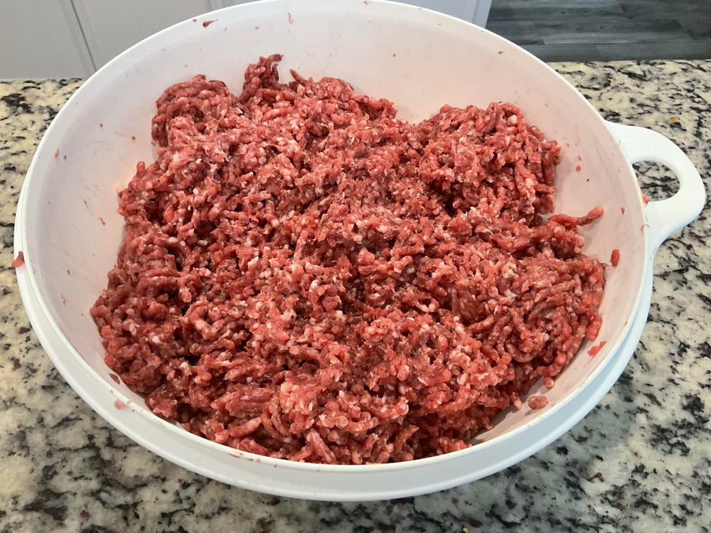 Deep Lake Trading Company packet beside kitchen scale and meat, illustrates yields up to twenty‑five pounds
