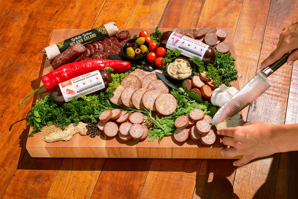 Deli Direct open box overhead view displaying meats, cheeses, and accompaniments