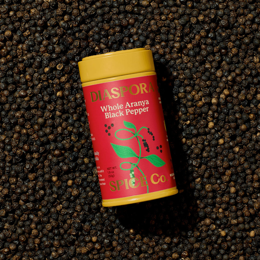 Diaspora Spice Co close-up of whole Aranya peppercorns highlighting texture and oil sheen