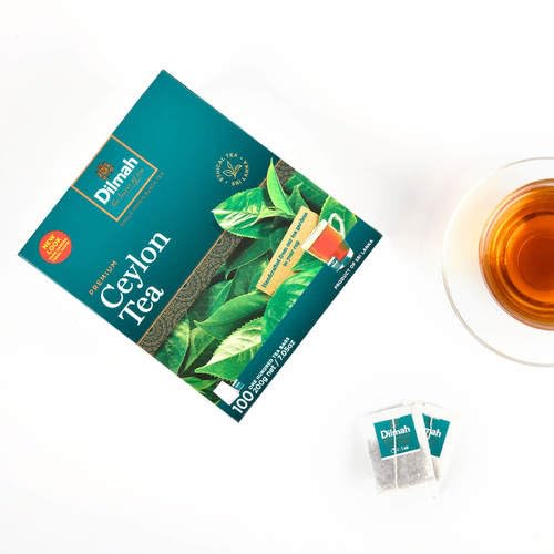 Person enjoying Dilmah tea in a cozy setting demonstrating comfort and everyday enjoyment benefit