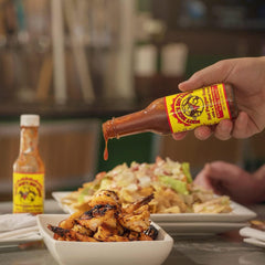 Dirty Dick's sauce drizzled on wings demonstrating flavor boost and balanced heat