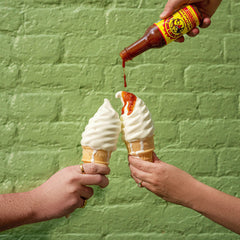 Dirty Dick's Peachy Green bottle close-up with fresh peach and green pepper notes benefit: bright heat