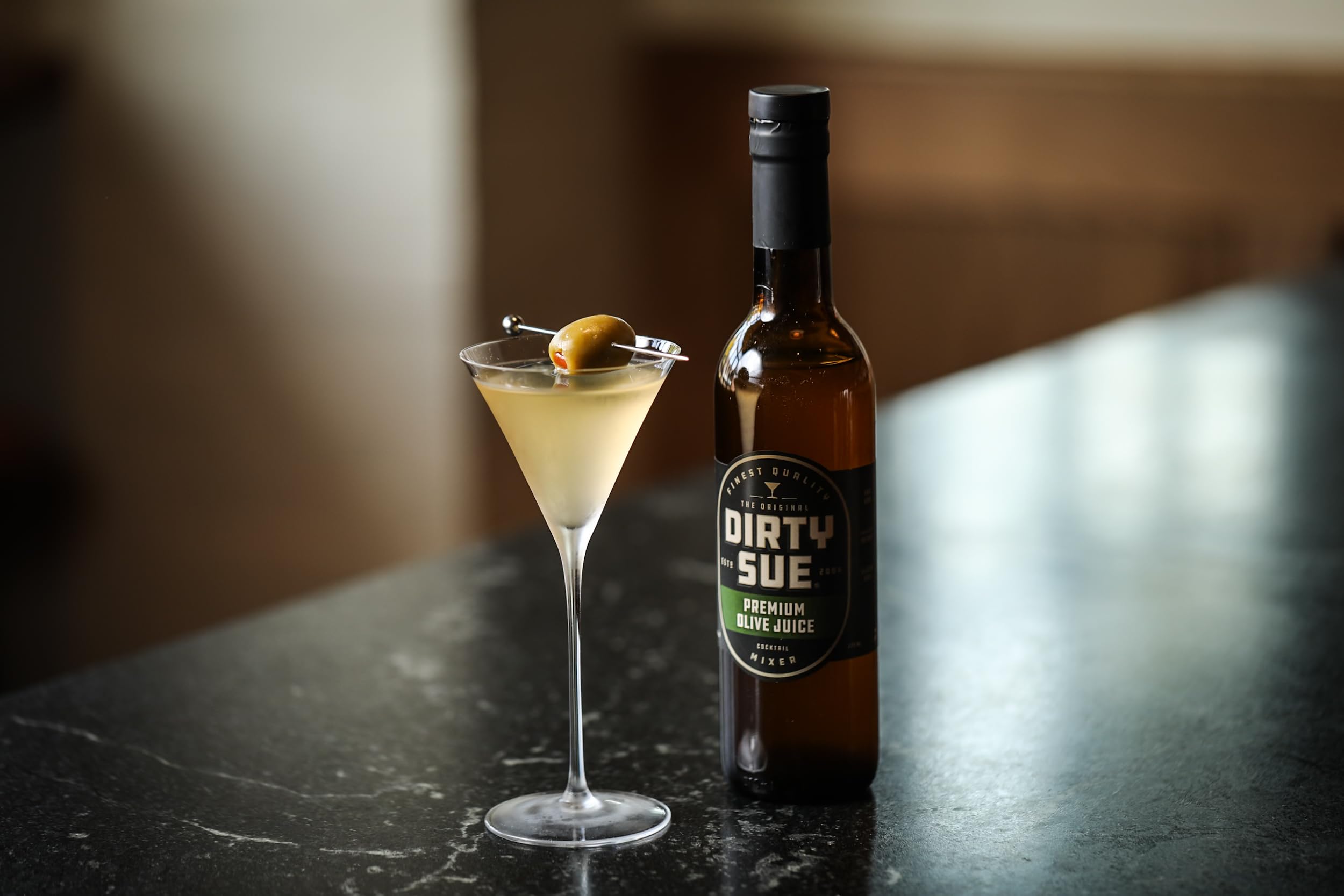 Dirty Sue pouring into a cocktail glass to demonstrate easy measured use