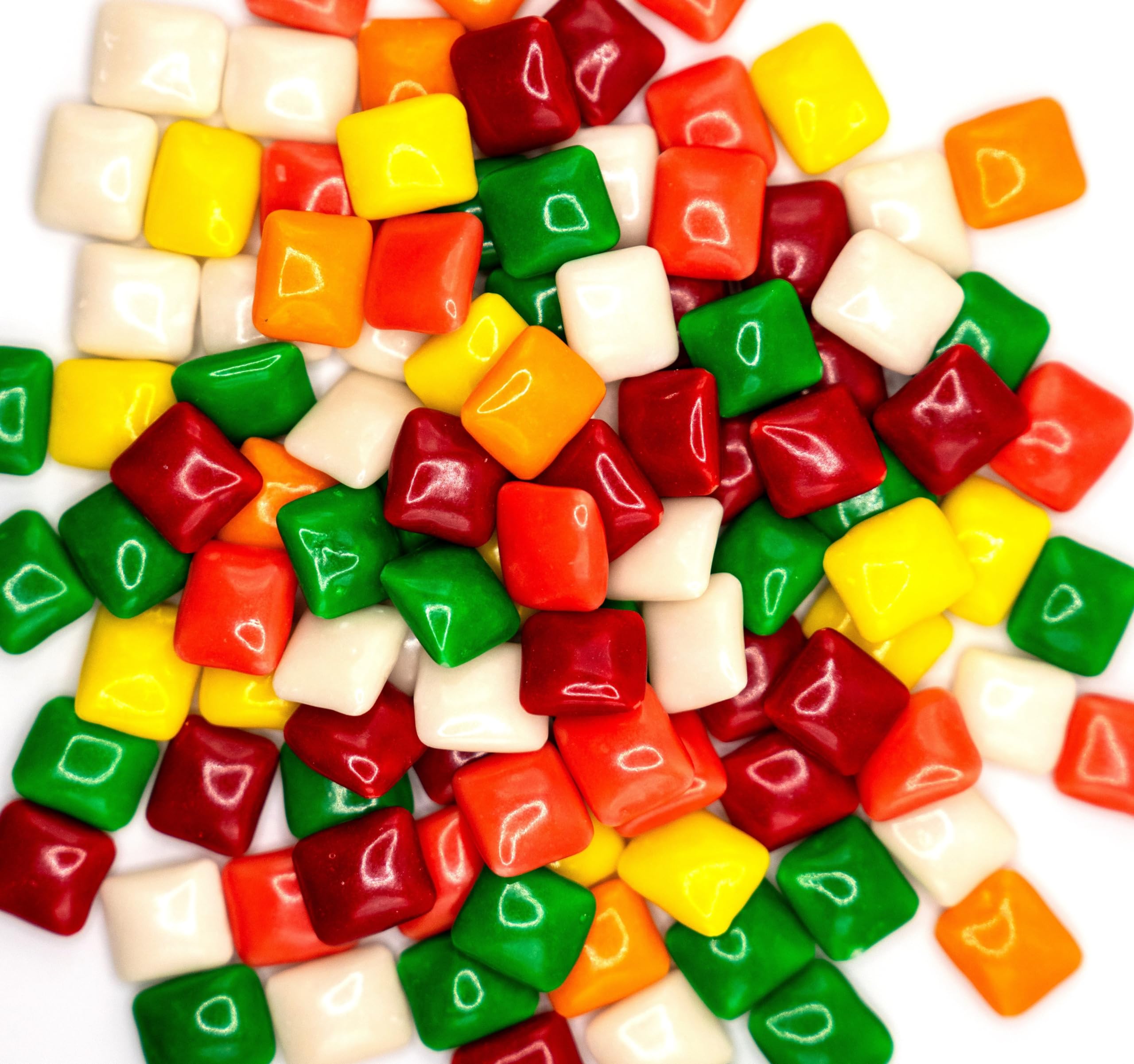 DM Sweets chiclets hand holding a piece showing size and portability benefit