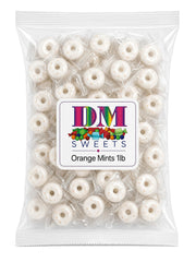 DM Sweets orange mints in a clear bowl at reception for attractive customer refreshment benefit