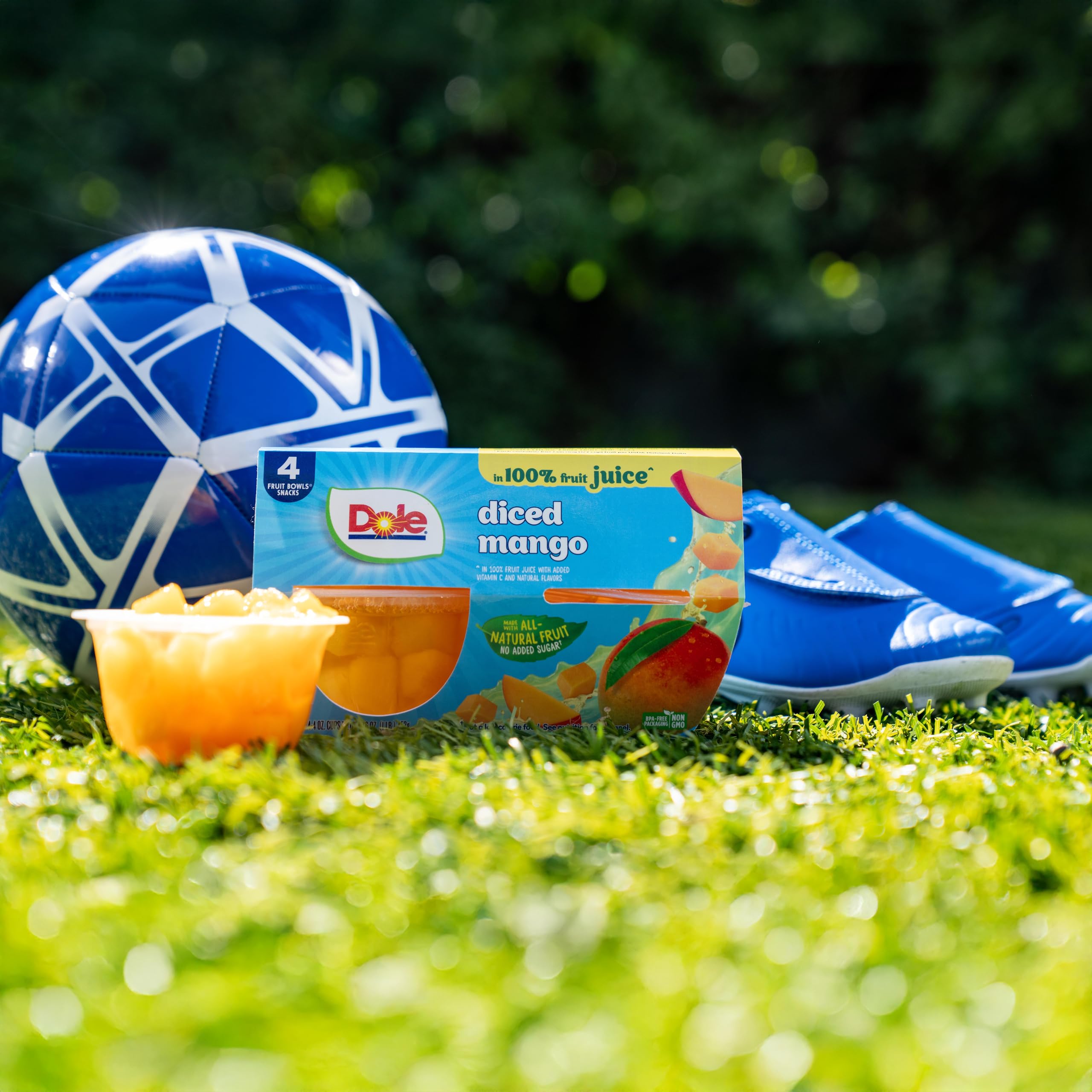 Dole spoonful of diced mango over yogurt adding flavor and easy serving
