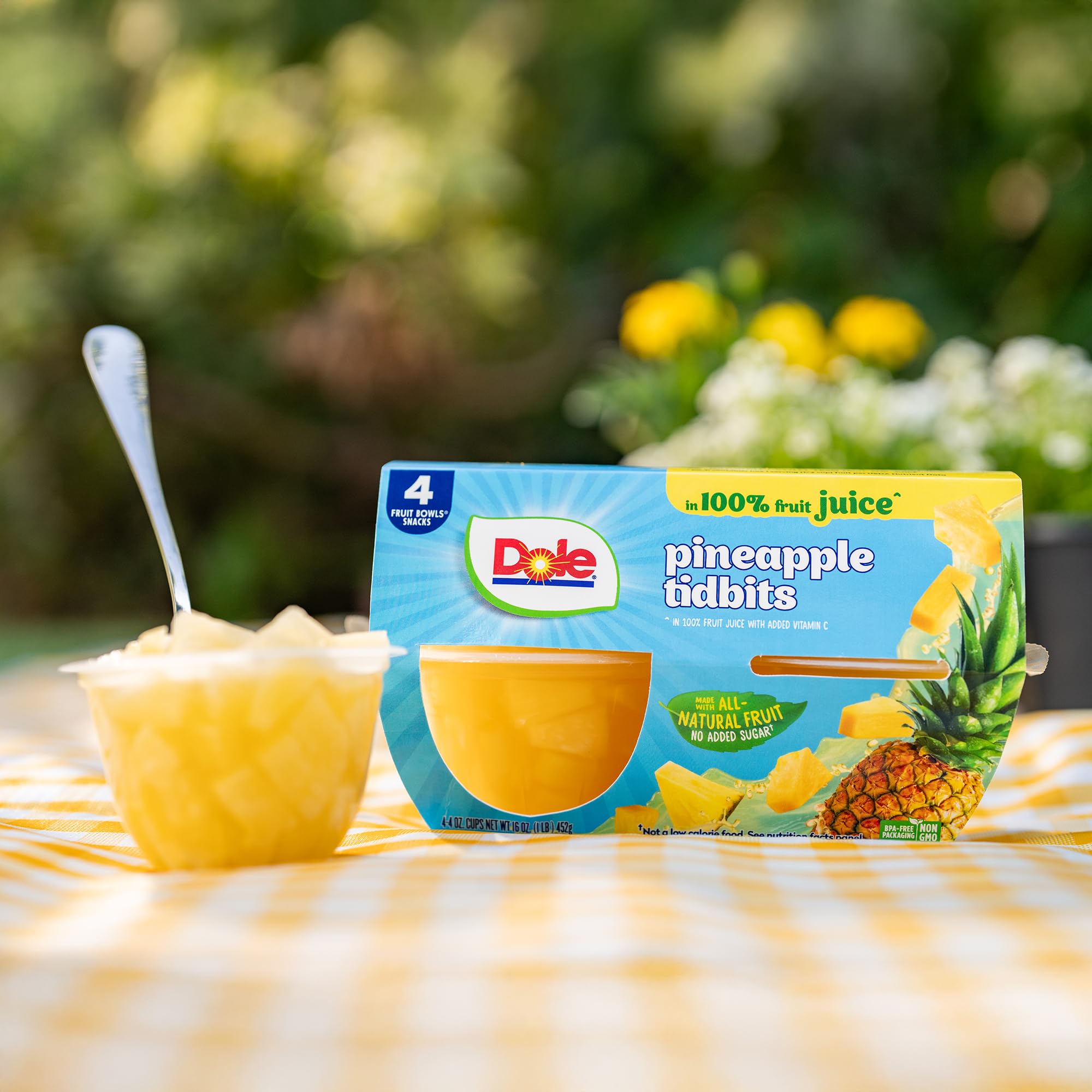Dole cup beside a measuring cup showing 4oz scale for portion control