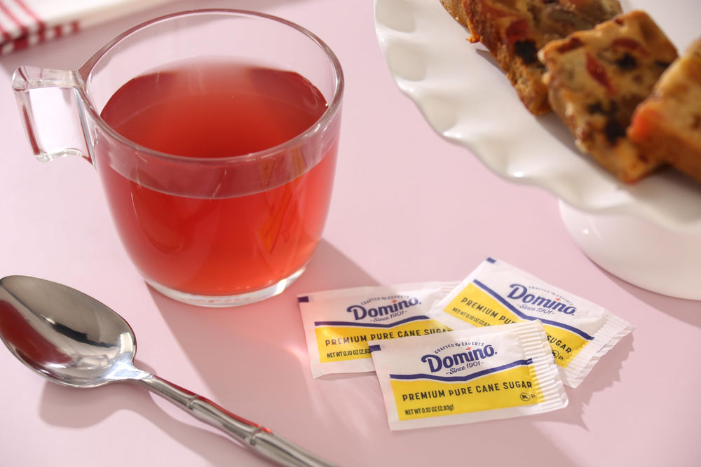 Domino packets on a cafe table next to cups showing professional presentation benefit