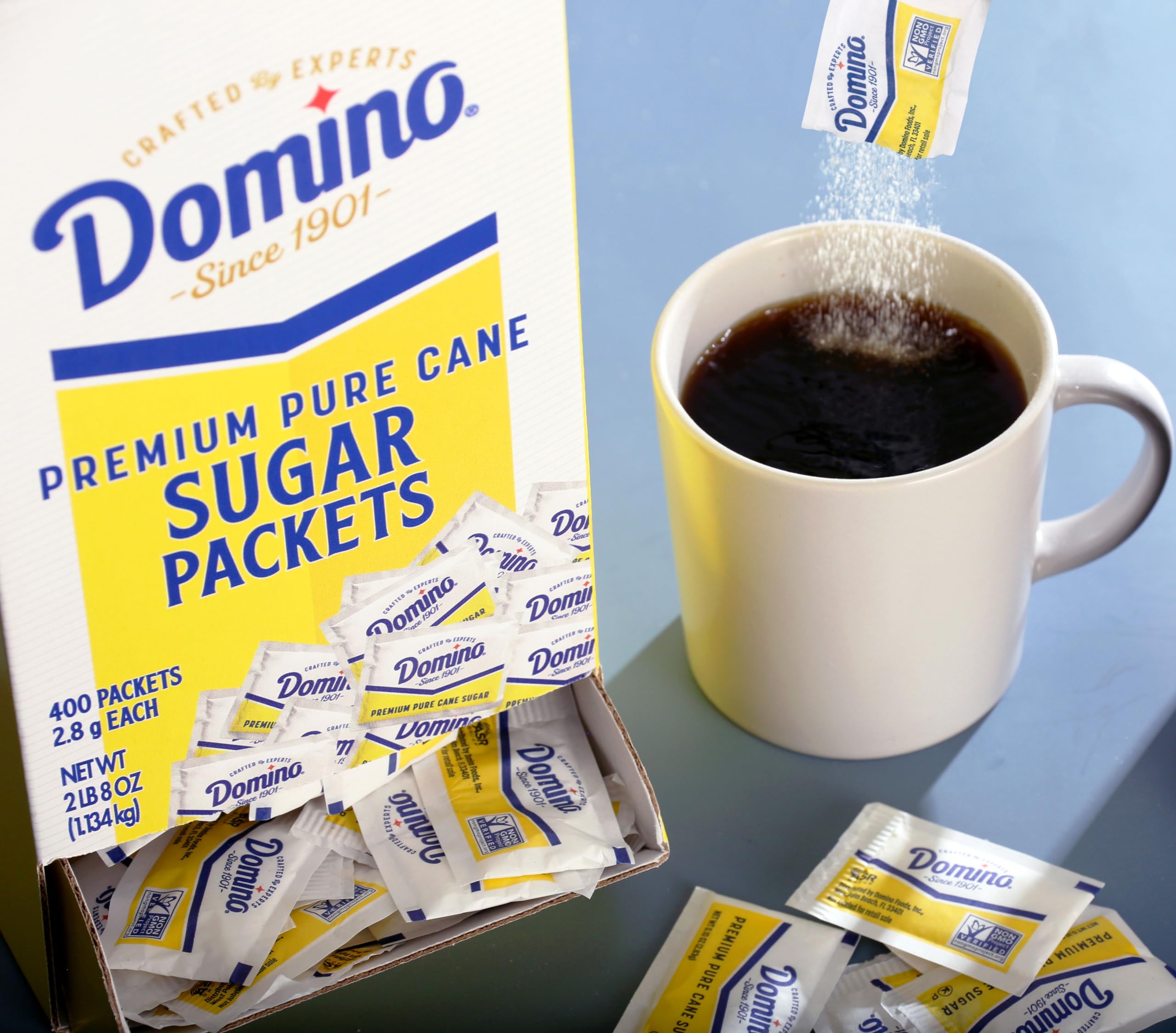 Domino dispenser box open with packets visible, easy-access benefit
