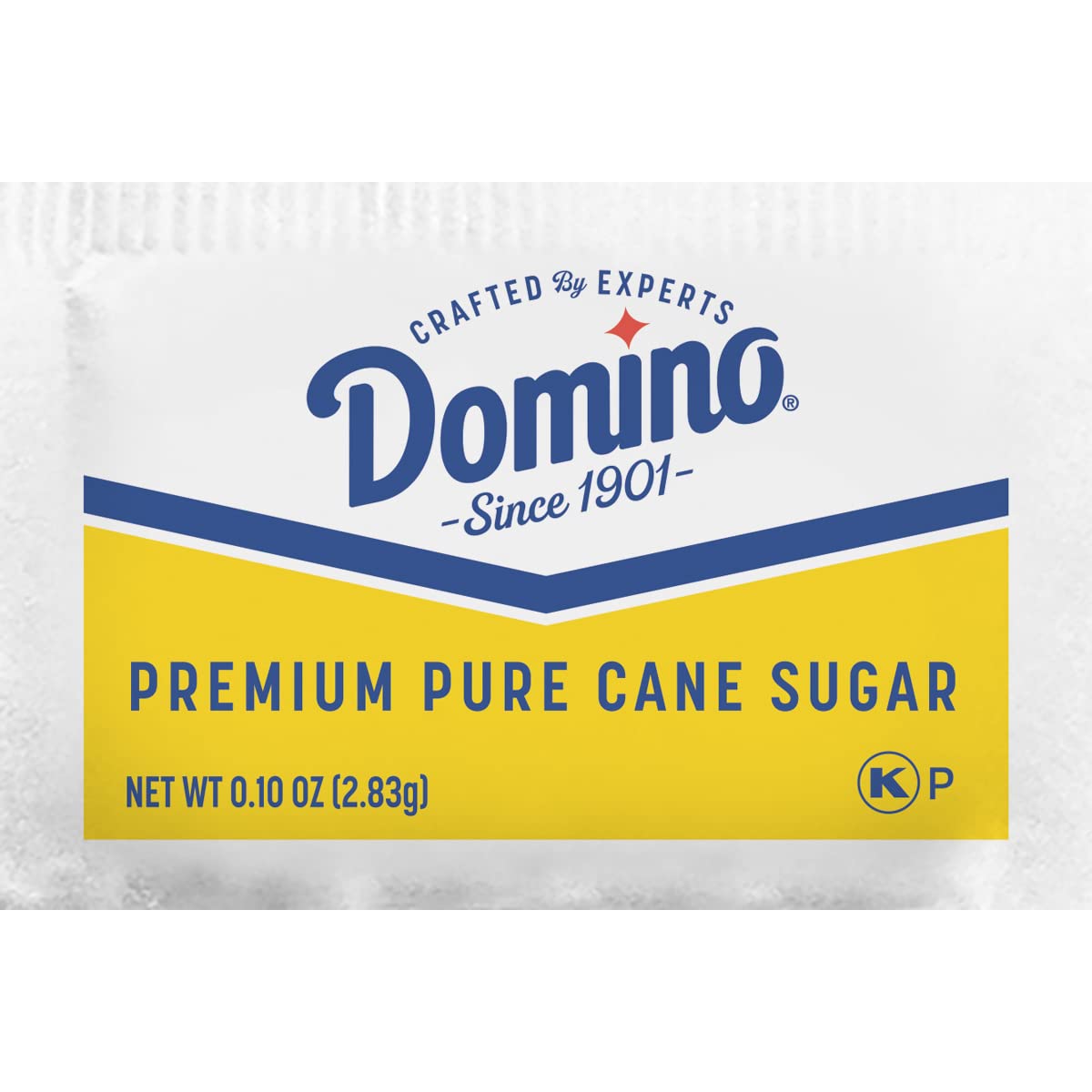 Domino packet close-up showing granulated cane texture and predictable sweetness benefit