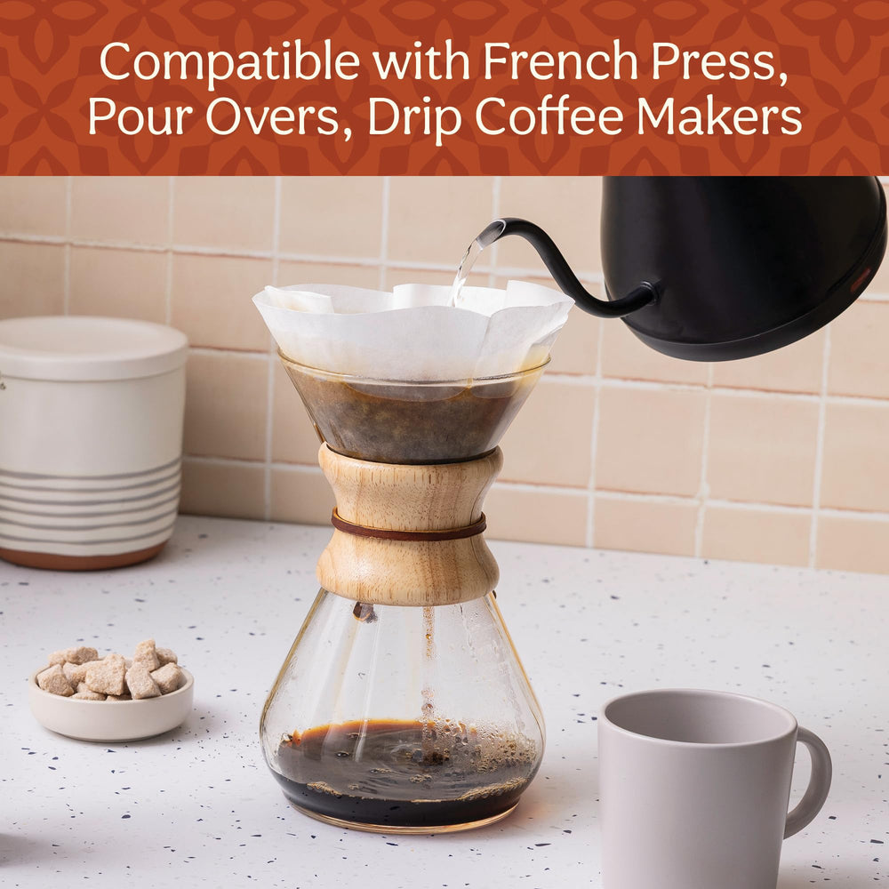 Don Francisco's pouring grounds into paper filter for precise brewing