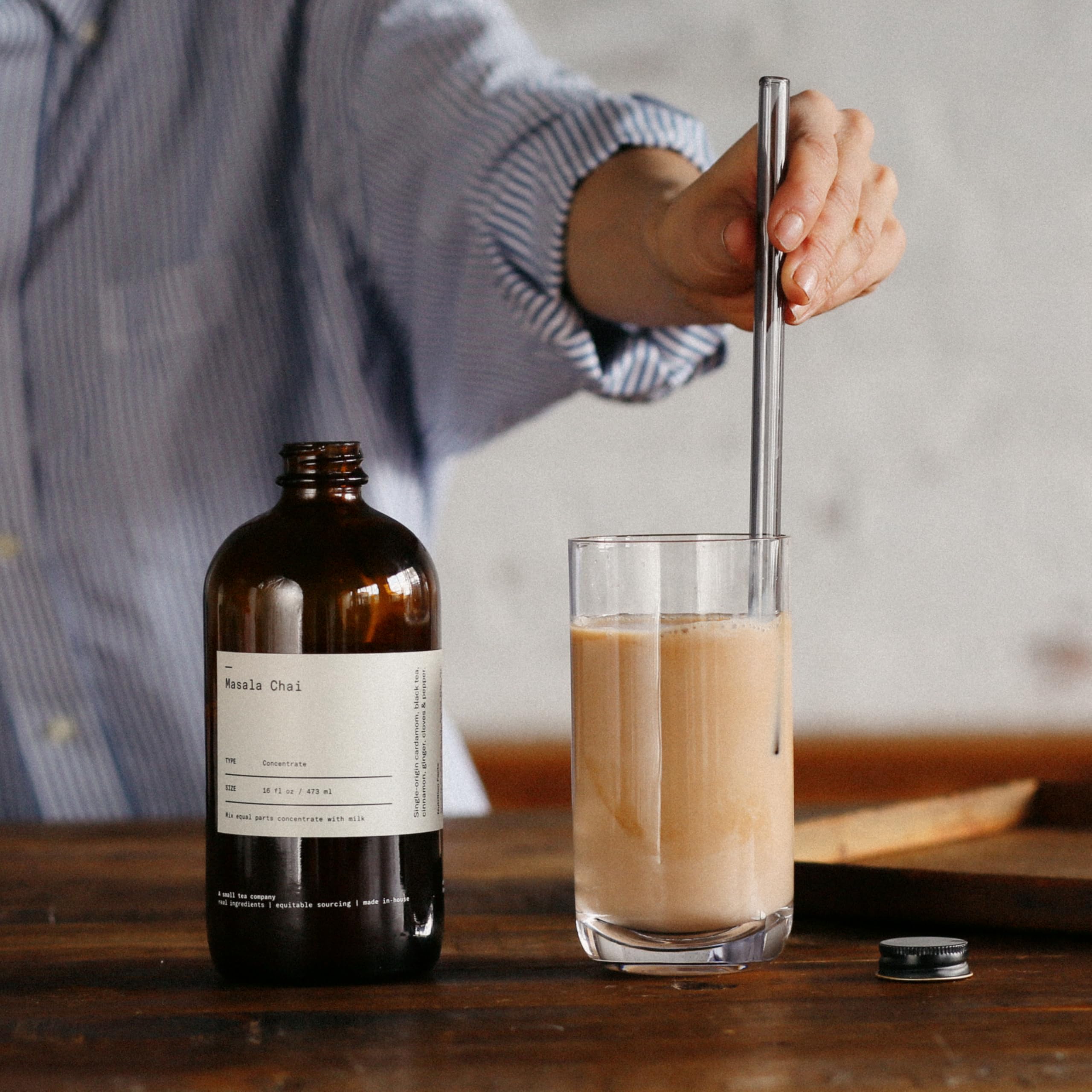 Dona Chai bottle beside a measuring cup showing 64 fl oz pack convenience