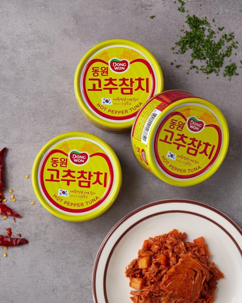 Dongwon tuna can beside common items for scale, compact and travel-friendly