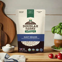 Open 1 lb bag of Doudlah Farms navy beans with wooden spoon for easy portioning and preparation