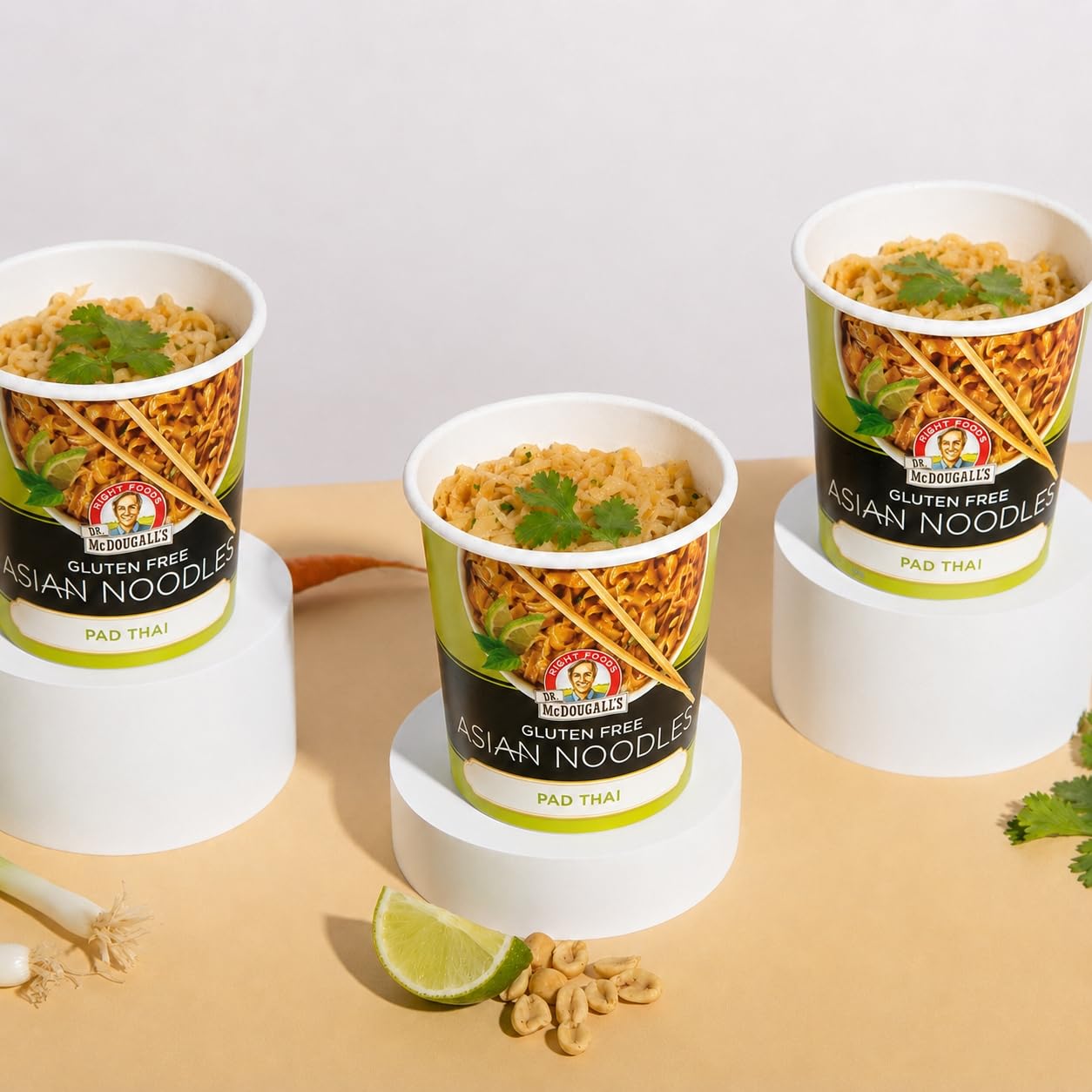 Dr. McDougall's Pad Thai cup beside a hand for portion size reference
