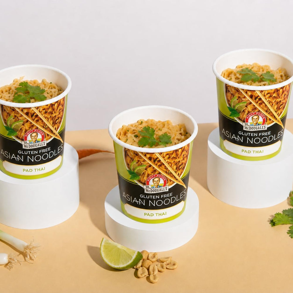 Dr. McDougall's Pad Thai cup beside a hand for portion size reference