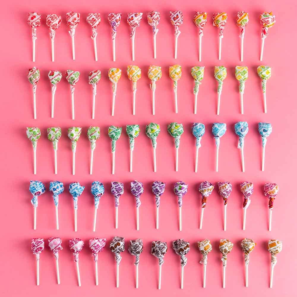 Dum Dums assorted flavors spread out to show 16 flavors and colorful variety for events