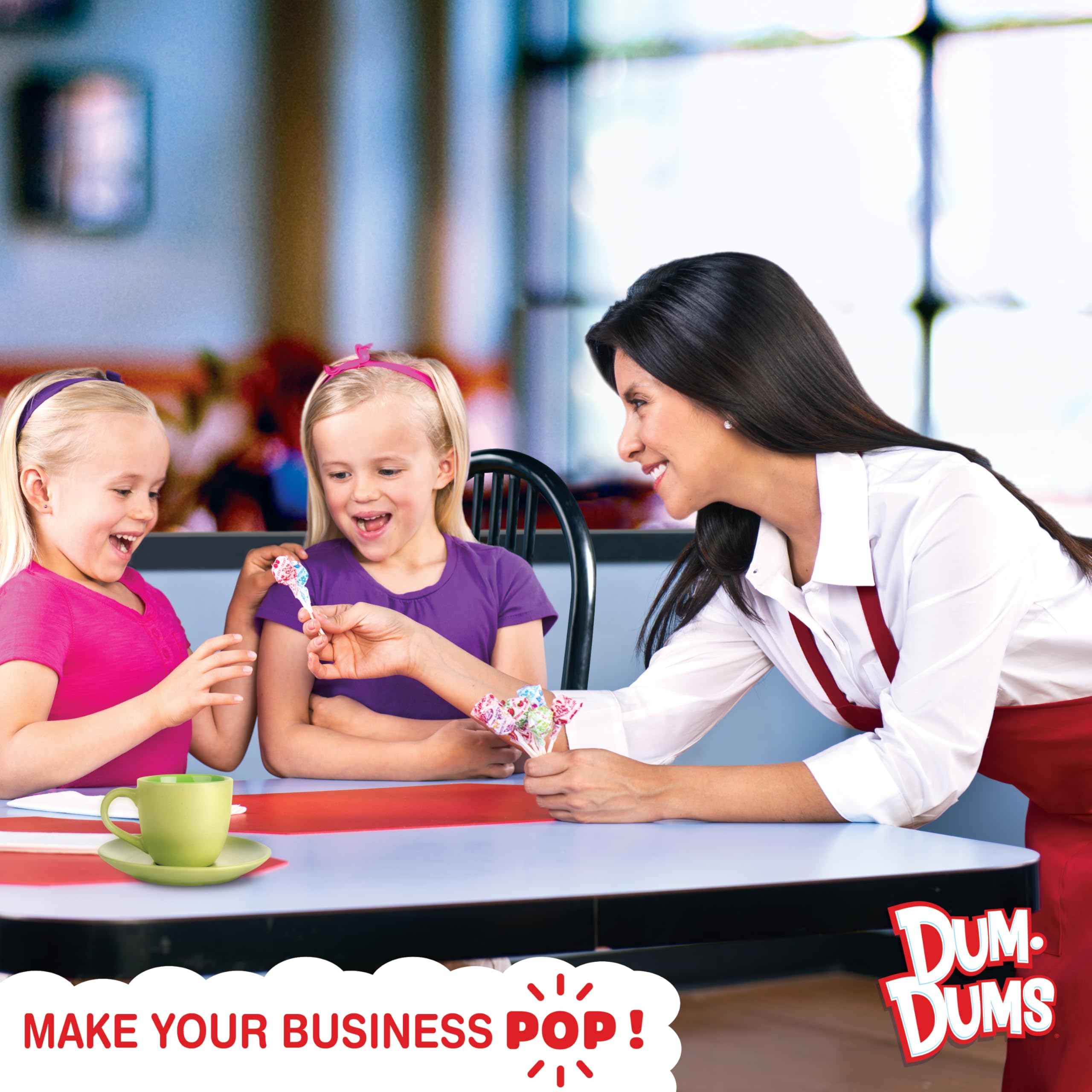 Hand holding Dum Dums lollipops demonstrating size and easy portioning benefit