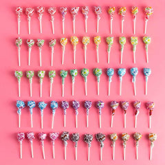 Dum Dums assortment top-down showing colorful mix of 16 flavors for variety