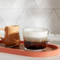 Poured Dunkin' French Vanilla coffee in a mug showing smooth creamy sip