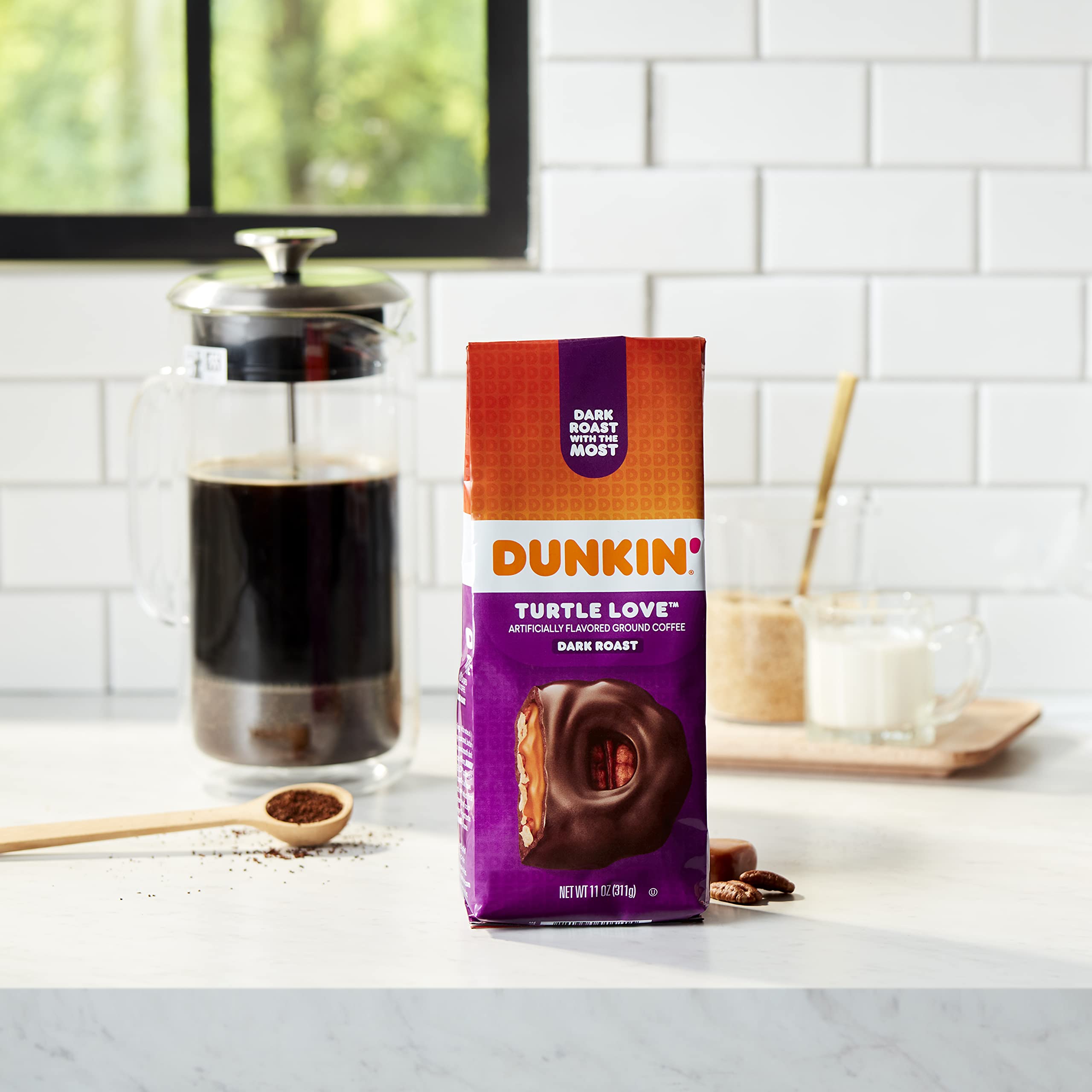 Dunkin' 11-ounce bag next to common objects showing compact size and portability